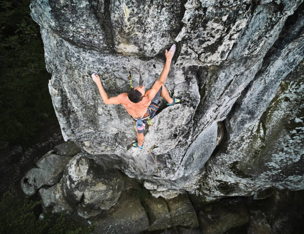 istock Male rock climber training rock climbing on a huge boulder 1367787635