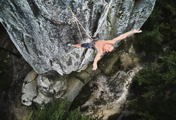 istock Male rock climber training rock climbing on a huge boulder 1367787636