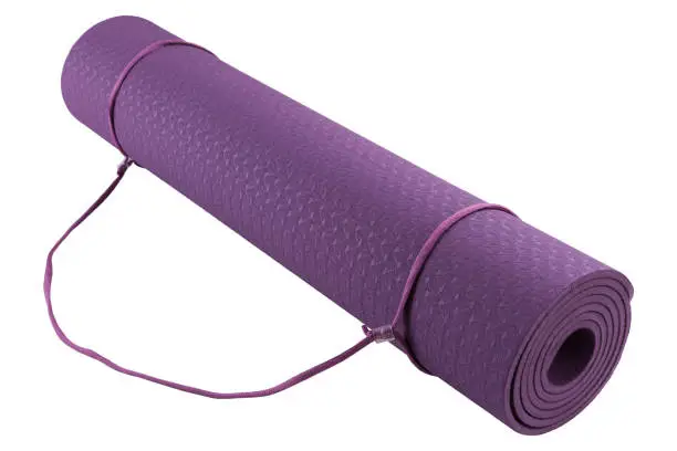 yogamat, purple mat in a roll for yoga or for fitness, on a white background, isolate