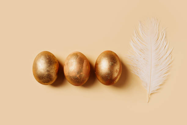 istock Happy easter concept with gold eggs on yellow and beige background 1367787906