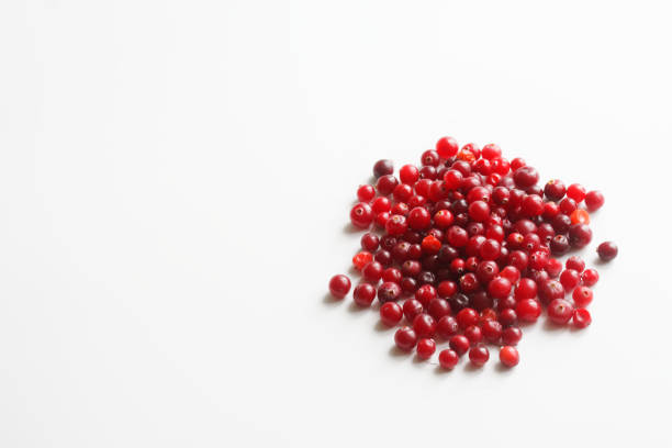 istock Many red cranberries on a white background. Free space for an inscription 1367788115