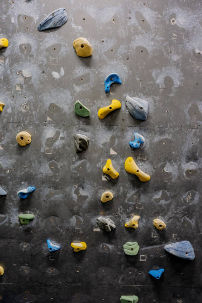 istock Arrangement of Rock Climbing Holds on Grey Wall 1367788996