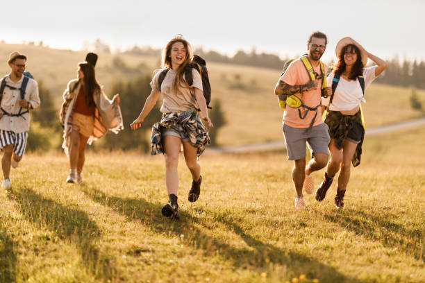 istock Young happy hikers running in spring day on a hill. 1367789234