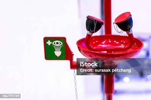 istock Red emergency eye washing station equipment with safety signage unit for chemical accident or critical 1367791739