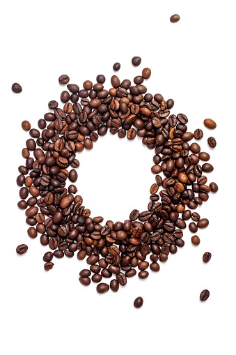 Round shape made by roasted coffee beans isolated on white background