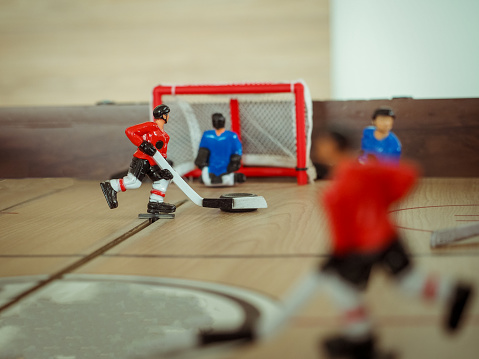table hockey. dynamic social game for fun. close-up of a striker with a puck.