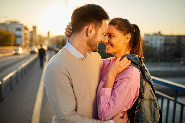 istock Young couple in love embracing on a bridge 1367794241