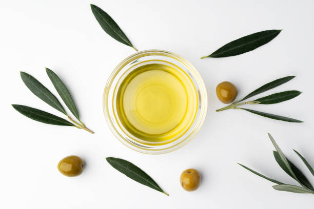istock Small bowl with olive oil and olives on white background, top view 1367795034