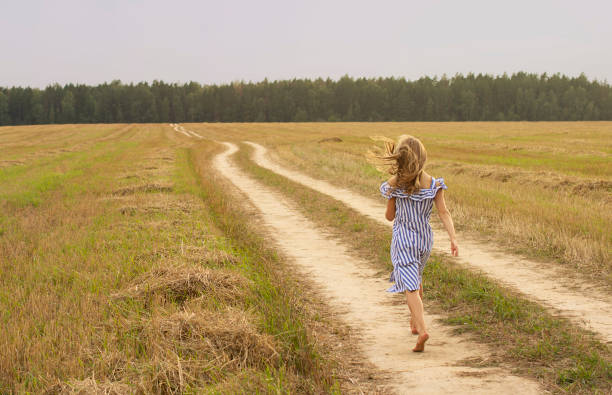 istock girl run in field 1367797629