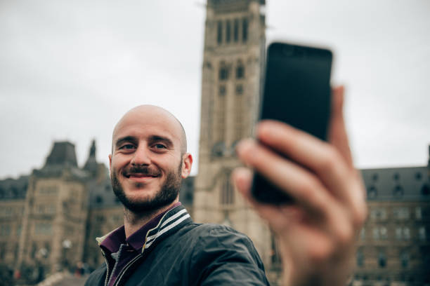 istock Man take a selfie in the city 1367799962