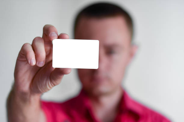 istock Man holding white business card 1367801529