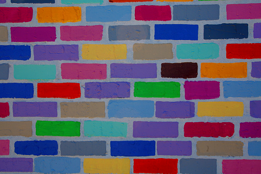 A brick wall painted in multicolour