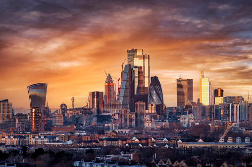 Elevated, panoramic sunrise view of the skyline of London City with the various modern skyscrapers reflecting the soft morning sunlight