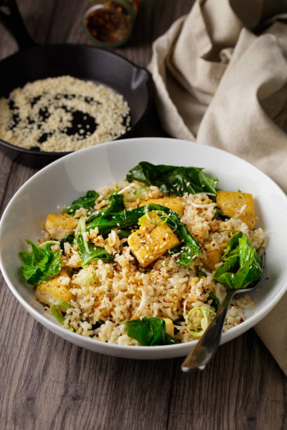 healthy vegan brown rice tofu salad - dieting front view vertical lifestyles imagens e fotografias de stock