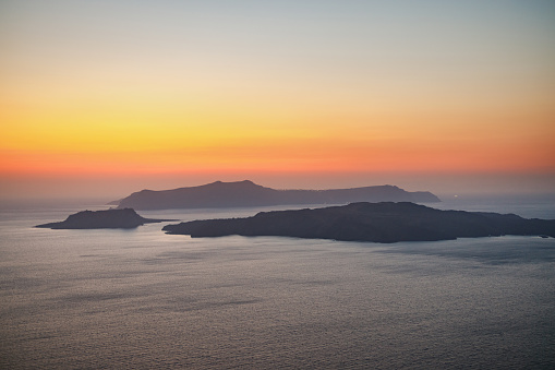 Seascape with three islands in Greece at sunset.