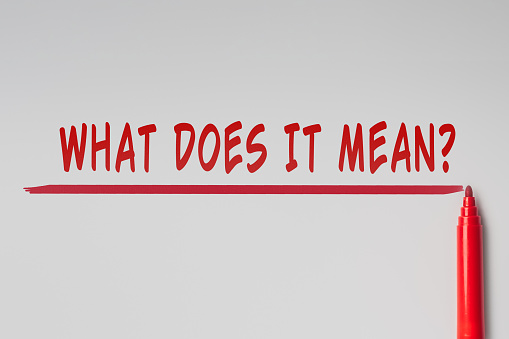 The text - What does it mean, written with red marker over red line on gray background. Concept