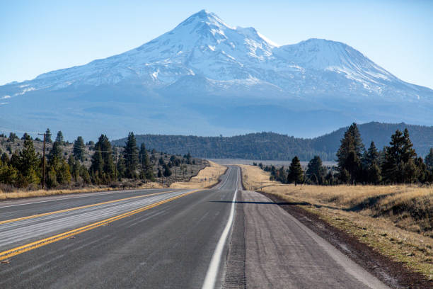 istock Curving road with mountain in the background 1367805141
