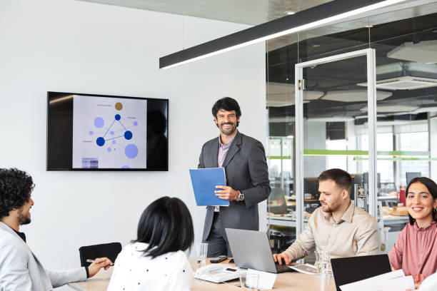 istock Businessman presenting to colleagues in meeting 1367805953