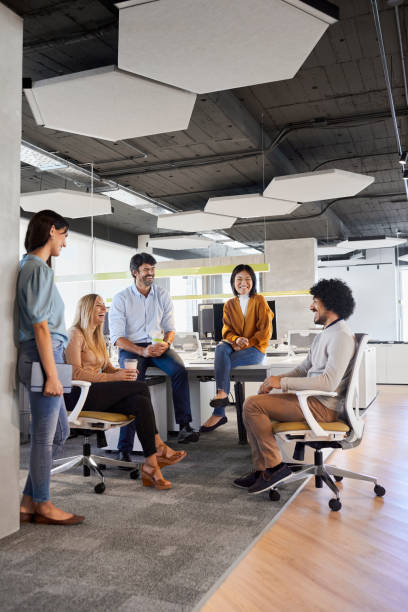 istock Manager discussing with coworkers in office 1367806484