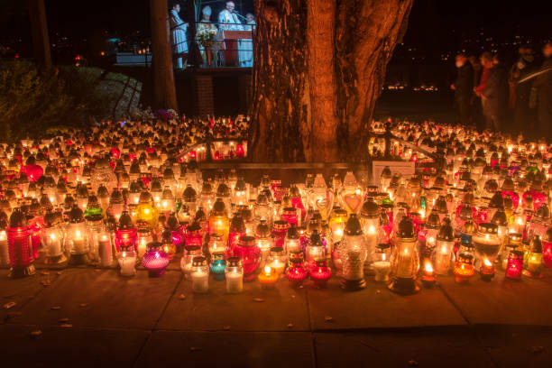 Gdansk, Poland - November 1, 2021: Graveyard candles on Polish cemetery during All Saints Day at night.