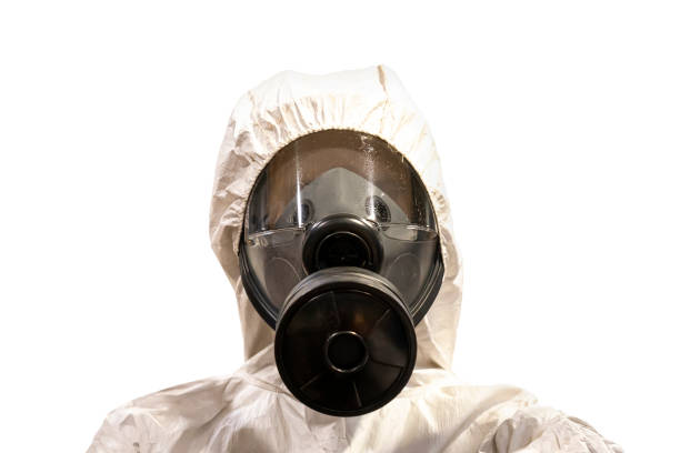 man in chemical protective clothing and half mask replaceable particulate filter respirator with glasses at white background, Safety virus infection concept