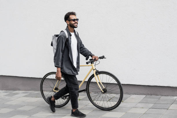 istock Handsome young man with bicycle in a city 1367809049