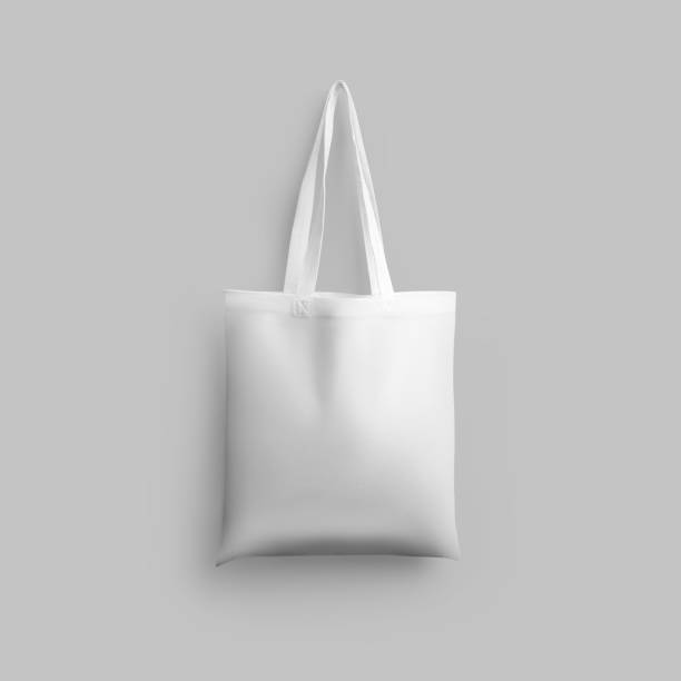 istock White cotton totebag mockup, isolated, hanging on wall background, 3d rendering. 1367810530