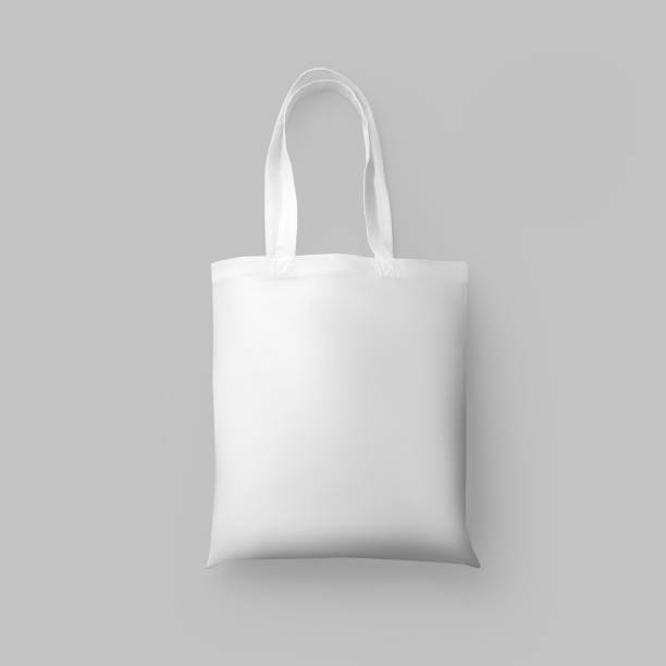 istock White cotton totebag mockup with handles, 3d rendering, wrinkle-free textural ecobag, isolated on wall background. 1367810662