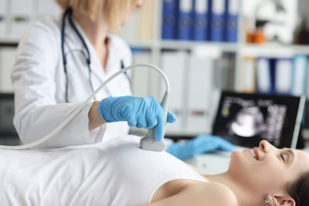 arzt, der ultraschalluntersuchung der brust der patientin in der klinik durchführt - ultraschall stock-fotos und bilder