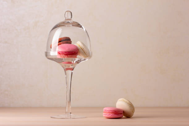 istock Tasty macaroons on cake stand with dome 1367813954