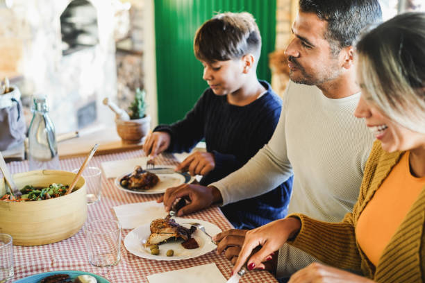 istock Latin parents having fun with their son during home dinner - Focus on father face 1367816418