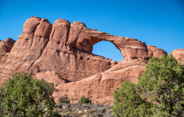 istock Double Arch ia a natural rock formation inside Arches National Park, Utah. Landscape under a blue sky 1367818652