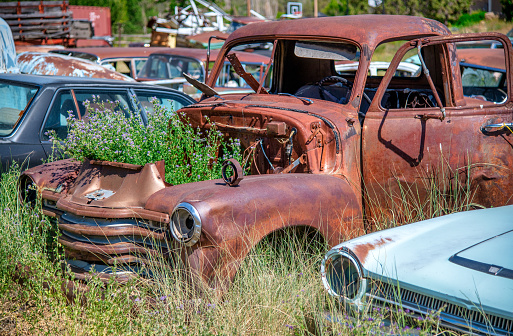 Glensdale, Utah - June 20, 2018: Rusty old cars under a blue summer sky.