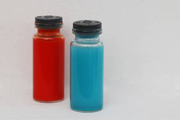 Bottoms of textured glass bottles in close up on pink background with copy space