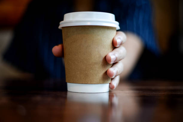 istock Hand holding hot coffee take away cup 1367820882