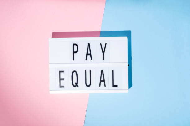 istock Pay Equal text on the lightbox. Concept of feminism on a blue and pink background. Top view 1367822304