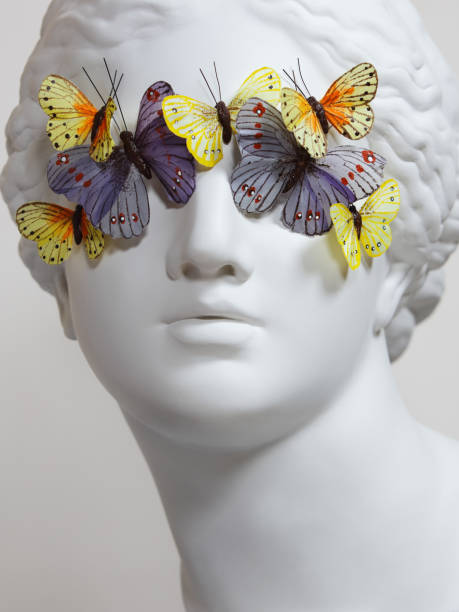 Greek Goddess with butterflies Plaster head model (mass produced replica of Head of Aphrodite of Knidos) with butterflies on her eyes sculpture stock pictures, royalty-free photos & images