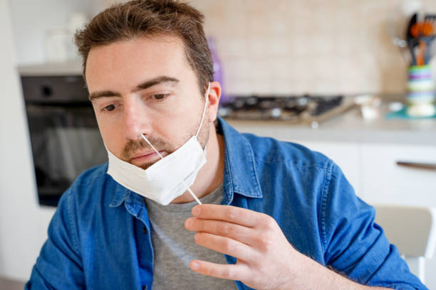 istock One man waiting test result by using rapid test device for COVID-19 1367822698