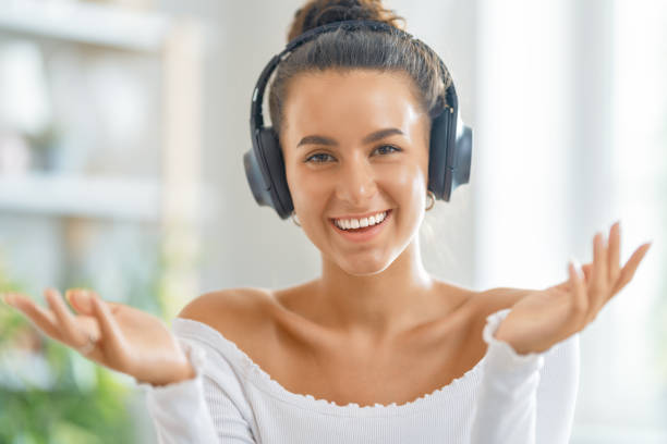 istock Young woman is using headphones. 1367825305