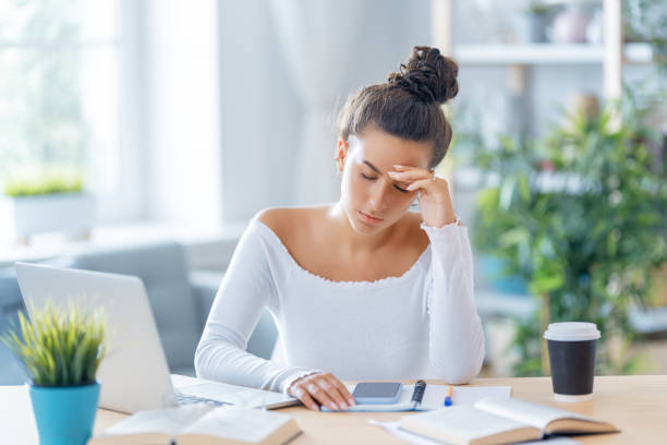 istock Young woman studying and having a head ache 1367825353