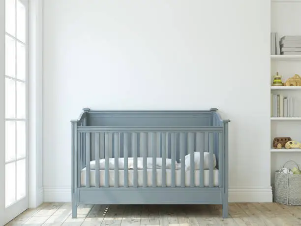 Modern nursery for boy. The blue crib near empty white wall. Interior mock-up. 3d rendering.