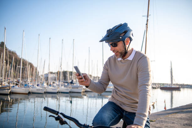 Man using smart phone on his bike