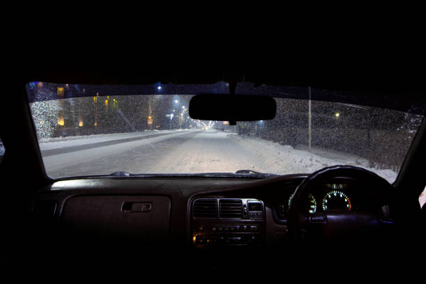 istock view from the car on a winter night with snowfall, the front and back background is blurred with bokeh effect 1367828013