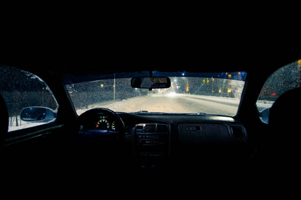 istock view from the car on a winter night with snowfall, the front and back background is blurred with bokeh effect 1367828163