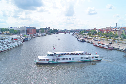 the photo shows how the ferry turns around on the Odra River in the city of Szczecin in beautiful sunny weather
