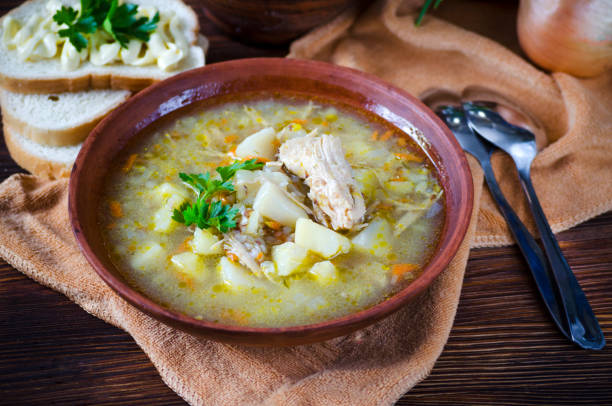 istock Buckwheat soup with meat in a clay bowl on the table. 1367831483