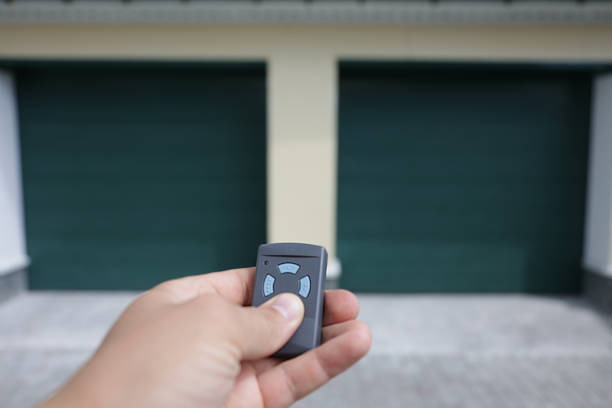 istock Man holds in his hand a remote control that opens the garage door 1367833270