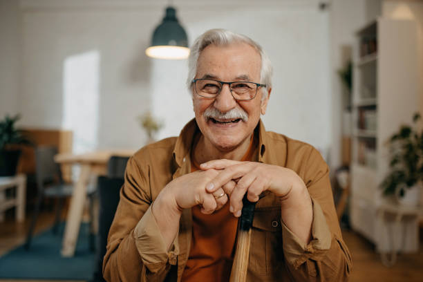istock Older man sitting  and relax with walking stick 1367834505