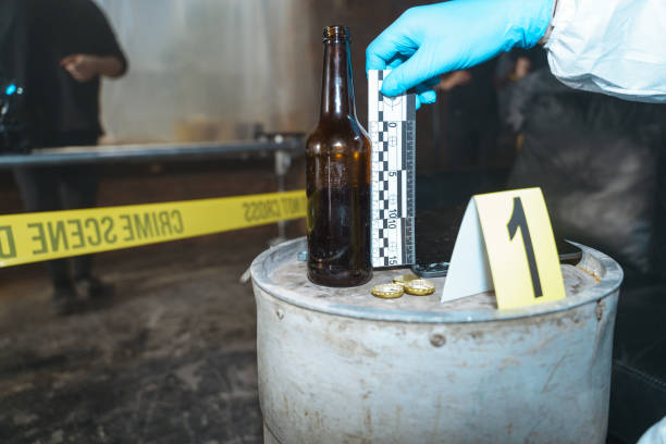istock Senior forensic scientist working at crime scene behind the barricade tape 1367834748