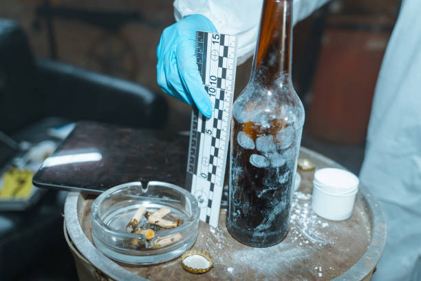 istock Forensic scientist at work, only his hand in a protective glove is in the frame 1367834764